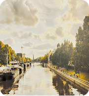 Sunlit canal and tree-lined waterfront